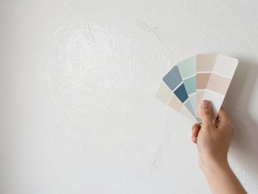 Bright editorial photography of a clean white primed wall surface being prepared for painting, bright natural light, professional surface preparation, 35mm