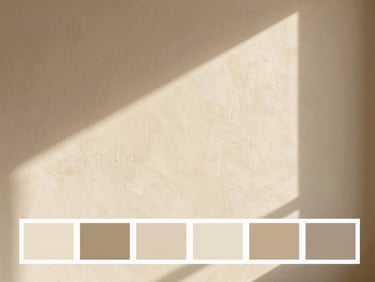 Bright editorial photography of a textured interior wall painted in a soft warm beige tone, natural side light casting gentle shadows, realistic paint texture, 35mm
