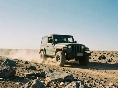 Low-angle shot of a Jeep climbing a rocky desert trail under harsh midday sun, dust in the air, expansive sky, 35mm film grain