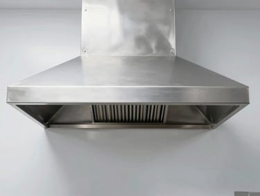 Symmetrical architectural shot of a pristine stainless steel commercial kitchen exhaust hood, bright cool daylight, sharp focus, 35mm