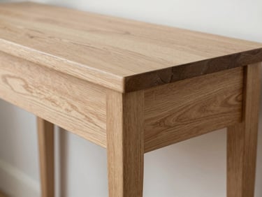 Close-up of a carved wooden console table showing precise joinery and matte natural finish, daylight