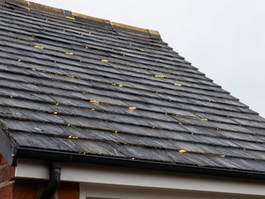 Close-up detail of flawless slate roofing with precise lead flashing on a residential home in Saddleworth.