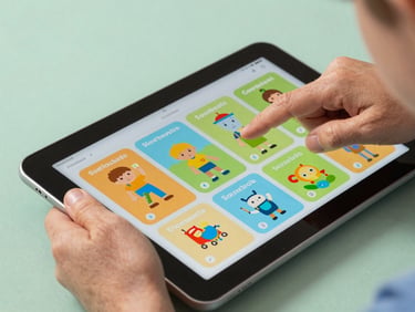 Macro close-up of a child's hand and an older adult's hand together holding a high-contrast Android tablet, interacting with a colorful, large-format educational layout under soft mint studio lighting.