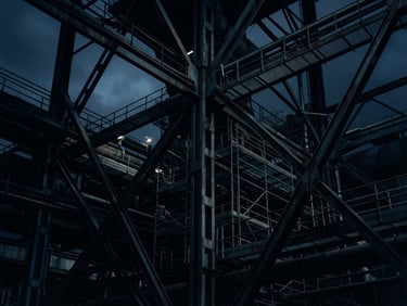Abstract architectural geometry of steel industrial structures, dark blue and slate grey tones, sharp lines, dramatic low-key lighting, 35mm