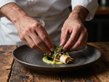 A close-up portrait of a chef's hands carefully plating a delicate seasonal dish, soft directional side light, dark ceramic plate, rustic wooden background.