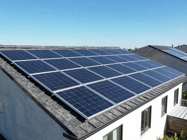 Overhead drone shot of a clean, newly installed solar array on a residential roof, showing precise panel alignment, under clear blue sky, bright sunlight.