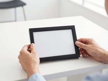 bright commercial photography, clean interior lighting, high contrast. Staff hands adjusting a modern frame on a clean counter, bright natural light