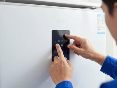 Close-up of technician's hands diagnosing an LG smart refrigerator control panel, crisp focus, bright indoor lighting, blue and white tones.