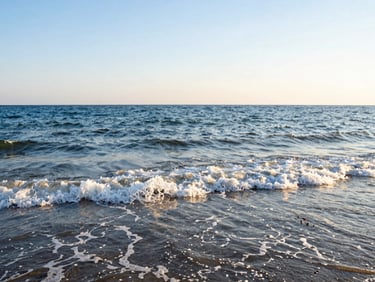Warm golden hour light reflecting on the waves of the Romanian Black Sea coast, wide-angle environmental shot