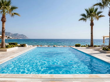 Luxurious coastal resort pool in Antalya directly adjacent to a vibrant blue sea, palm trees, bright midday sun