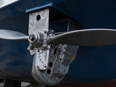 close-up of a ship's propeller, sharp technical photography, cold overhead workshop lighting, desaturated steel
