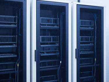 Minimalist modern server rack with clean cabling, natural daylight, deep blue and sharp white tones, sharp focus