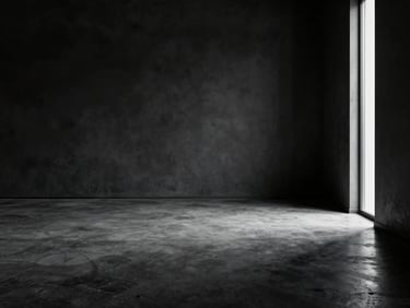 Wide panoramic shot of an empty dark luxury interior — polished concrete floor, a single narrow column of natural light entering from a tall unseen window on the far right, the rest of the room in deep shadow, architectural geometry visible only through tonal contrast, no furniture, no people, no text
