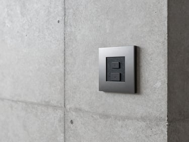 Minimalist residential living room with concrete walls, flush-mounted control interface, crisp architectural photography.