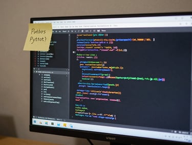 Close-up of a monitor showing a Python or JavaScript terminal with colorful output lines scrolling, a small sticky note on the monitor bezel, neutral studio lighting