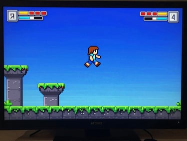 Wide game screen capture showing a side-scrolling platformer level with a pixel character mid-jump, electric blue background sky, platforms in green and gray, score and lives UI in top corners, monitor frame barely visible at edges
