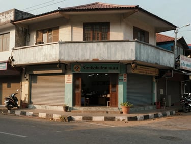 Ground-level shot of a commercial ground-floor shop unit in Srikakulam town's main commercial street, shutter-front unit, wide road frontage, afternoon daylight