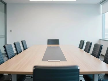 An empty, formal conference room with a large table, chairs neatly arranged, cool corporate tones, bright natural light