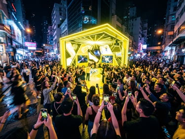 Wide-angle environmental shot of a vibrant nighttime street activation, a glowing electric-yellow branded pavilion surrounded by an energetic crowd of people pulling out their phones, dramatic high-contrast ambient lighting.