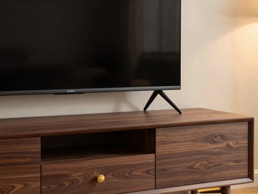 Sleek television unit made of rich dark walnut, styled with modern accessories, warm architectural lighting.