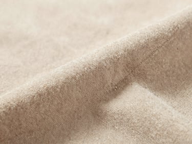 High-fidelity close-up of plush fabric textures and stitching details, soft natural daylight, macro lens focusing on fabric texture, warm neutral backdrop