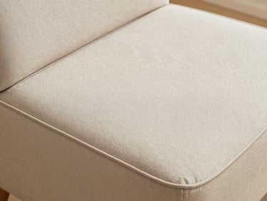 A clean, modern seat cushion with structured piping edges, soft diffused daylight highlighting the textile weave