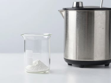 A clean laboratory beaker with amino acid powder next to a steel shaker, bright studio lighting, medical aesthetic