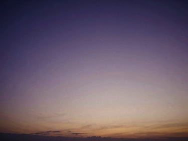 Extreme wide angle twilight landscape, deep violet sky with a faint warm amber glow on the horizon, soft focus 35mm film photography, expansive negative space.
