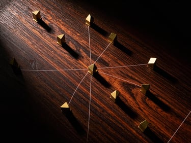 High-contrast top-down shot of a tactical map with geometric brass markers, dark wood surface, deep shadows, 35mm film grain.