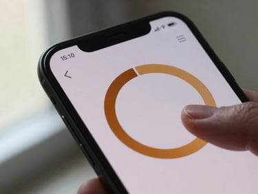 Extreme close-up of an Android phone screen showing a clean timer interface with a warm amber progress ring, single finger resting at the edge of the display, soft natural window light from the left