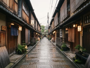 Wide environmental shot of a quiet historic street in Kyoto at dawn. Soft overcast morning light reflects on wet stone pavement. Traditional wooden machiya buildings line the narrow alley, showcasing rich textures and desaturated earth tones. Warm editorial travel photography, 35mm film look, natural depth of field.