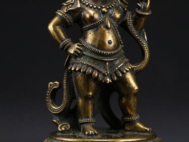 Macro shot of an ornate antique bronze figurine, intricate details, rich patina, dark background.