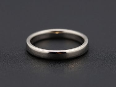 Macro shot of a minimalist platinum ring, clean lines, subtle metallic sheen, dark background.