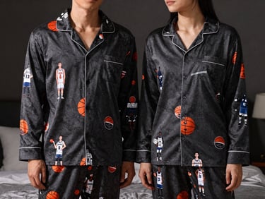 Matching couple pajamas with athletic and basketball team inspired prints, cozy bedroom setting, soft lighting