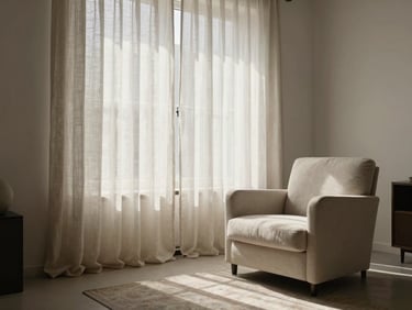 Minimalist, quiet living room in Barcelona, soft morning daylight filtering through linen curtains, a comfortable armchair, elegant neutral decor, peaceful atmosphere.