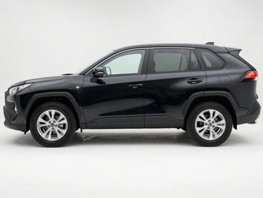 Side profile of a black Toyota RAV4 on a white studio surface, overcast daylight from left, showing full body length and roof rails
