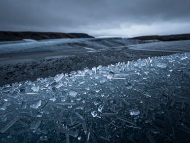 Extreme macro close-up of pure glacial ice texture, sharp crystalline structures, cold blue and charcoal tones, high contrast lighting.