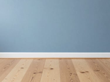 Crisp architectural detail of newly installed light oak flooring meeting a freshly painted slate blue wall, bright Seattle overcast daylight, sharp focus, 35mm