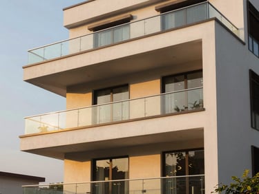 A modern three-story luxury independent floor in DLF Phase 2 Gurgaon, sharp clean architectural lines, warm golden hour sunlight reflecting off glass balconies, professional architectural photography