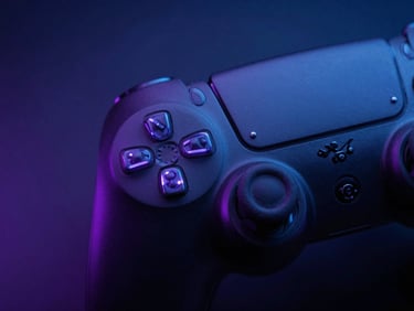 Macro close-up of a matte-black PlayStation controller with glowing neon purple light reflecting off the textured grips, moody ambient lighting.
