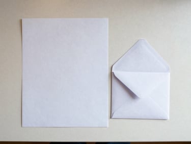 Flat-lay overhead of a filled offer sheet and a white envelope on a clean counter, crisp studio daylight, no hands, documentary framing