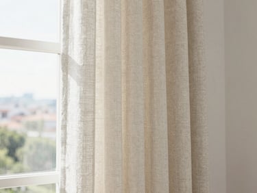Elegant neutral-toned linen curtains hanging in a modern sunlit Bogotá apartment, soft focus, pristine clean atmosphere