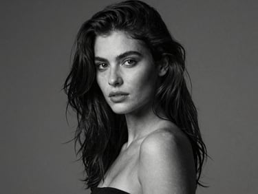 Artistic black and white portrait of model Camila, dramatic lighting, high contrast, studio background