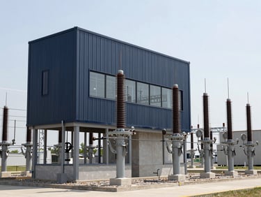 Crisp architectural photo of a modern US power substation, cool natural daylight, desaturated steel and navy tones, sharp focus, 35mm architectural lens