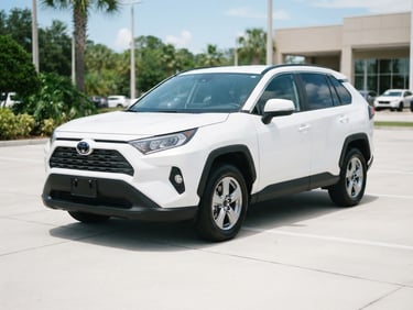 Crisp eye-level portrait of a clean, practical white SUV parked on a neat concrete lot under bright natural Florida daylight.
