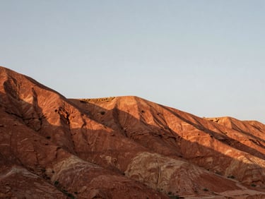 Wide panoramic low-angle shot of red clay mesa formations under a crisp overcast sky, sharp geological layers, medium format film.