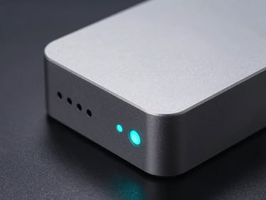 Extreme close-up of a compact aluminum Mini PC chassis, sharp metallic textures, glowing cyan status LED, dark slate background, cool studio strobes