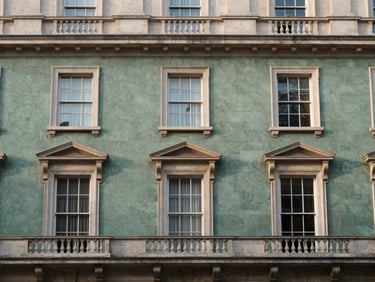 Symmetrical architectural detail of a classic London townhouse facade, soft morning light, muted slate and stone tones, editorial 35mm photography