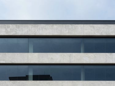 Minimalist architectural photography of a modern office building in Hyderabad, clean concrete lines, soft overcast natural daylight, 35mm