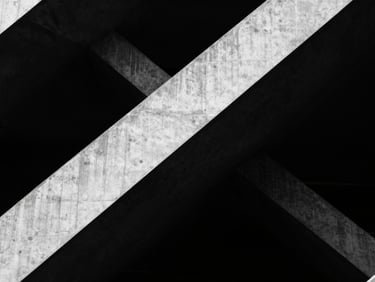 Abstract architectural geometry, sharp concrete angles, dramatic shadows, stark high-contrast monochrome